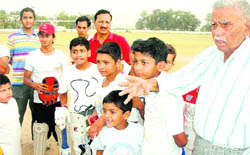 Children taking tips from an expert at the cricket coaching camp-cum-workshop at BHEL in Haridwar on Friday.