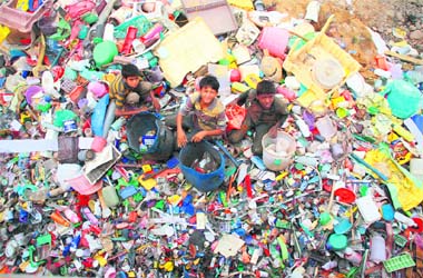 Mohd Rizvaan, Mohd Yousaf and Mustafa Kamal segregate scrap at Narwal bypass near Bhatindi in Jammu