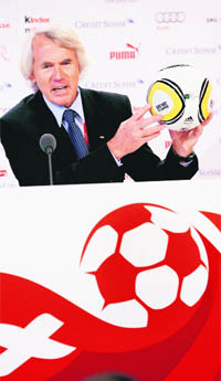 FIFA Chief Medical Officer, Jiri Dvorak, shows the  World Cup ball with an inscription, "Say No! To Doping" during a media conference in the training camp of Switzerland's national soccer team in Crans-Montana, Switzerland, recently  