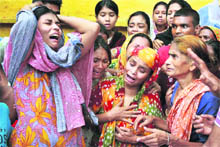 Relatives mourn the death of a fire victim Dhaka on Friday. 