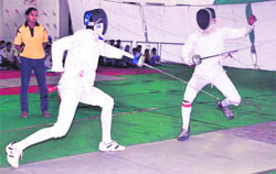 Players in action during the inaugural match of the 2nd Federation Fencing Cup at Punjabi University in Patiala on Saturday.
