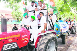 Punjab Youth Congress President Ravneet Singh Bittu drives a tractor-driven tanker to water saplings in Mohali on Saturday