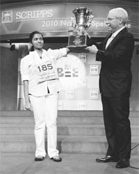 Anamika Veeramani (left) of New Royalton, Ohio, holds the trophy with E.W. Scripps Company CEO Richard Boehne after winning the 2010 National Spelling Bee in Washington