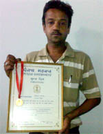 Vinod Bansal showing the appreciation certificate he was awarded by the state government in 2006