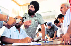 Officials return cheques to traders in Ludhiana on Sunday