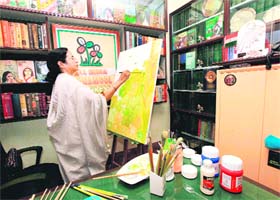 Master stroke: Railways Minister Mamata Banerjee paints a picture at her Kalighat residence in Kolkata