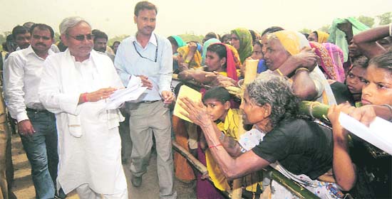 Bihar Chief Minister Nitish Kumar listening to problems of villagers during his Vishwas Yatra at Dharhara village in Bhagalpur, Bihar