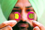 An artist shows the smallest traditional handmade fans in Amritsar on Sunday