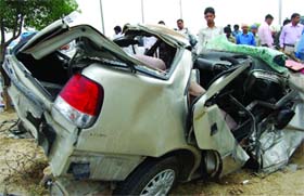 The wrecked remains of a car that met with an accident after its tyre blasted on the Noida-Greater Noida Expressway near Jhatta Badoli village early morning today