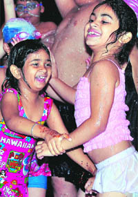 Kids enjoy rain dance at a club in Ludhiana on Monday.