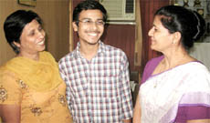 Fifth-ranked Bhrigu Jain shares a happy moment with his mother (on his right) and principal of the RB DAV Senior Secondary School in Bathinda on Monday.