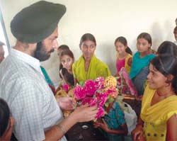 Deputy Commissioner Gurkirat Kirpal Singh interacts with a trainee after inaugurating a free self-employment training camp in Bathinda on Monday.