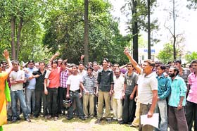 Safai karamcharis of the DMC hold a demonstration in Dehradun