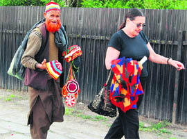 A Kashmiri vendor tries to convince a tourist to buy his articles in Srinagar.