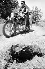 A caved-in road poses threat to commuters at Pabhat village in Zirakpur
