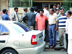 People gather outside the shops at Adarsh Nagar in New Delhi on Wednesday