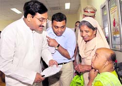 Uttarakhand Chief Minister Ramesh Pokhriyal Nishank listens to a patient at the Janata Darshan programme in Dehradun on Wednesday