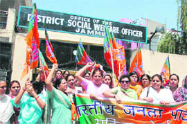 Members of the BJP Mahila Morcha protest in front of the office of the District Social Welfare Officer in Jammu on Wednesday.