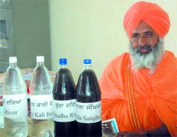 Sant Balbir Singh Seechewal showing samples of highly polluted water of various drains of Punjab, in Bathinda, on Thursday