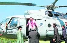 Sri Lankan President Mahinda Rajapaksa alights from a Indian Air Force helicopter upon his arrival at Annandale in Shimla on Thursday.
