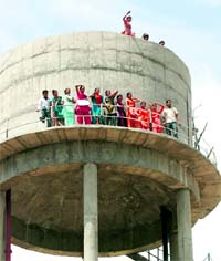 AIE teachers climb atop a water tank to lodge a protest 