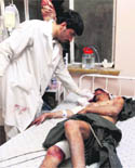 A medico helps a wounded man at a hospital following a blast at a wedding party in Kandahar city on Thursday. 