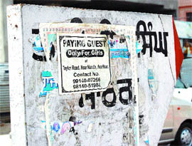 A signboard showing way to Bhai Vir Singh Marg defaced with advertisement leaflets. (Right) an MC signboard wrongly mentioning the name of the road as Lawrence Road in Amritsar.