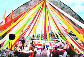 Tourists enjoying organic food at the Organic Fair and Food Festival being organised at the Indira Gandhi sports complex in Shimla on Friday. 