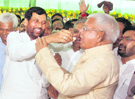 RJD chief Lalu Prasad Yadav being offered a piece of cake by Lok Janashakti Party chief Ram Vilas Paswan during his 63rd birthday celebrations in Patna.