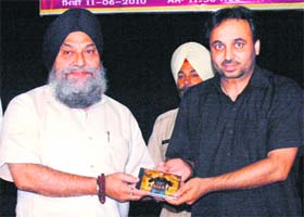 Bhagwant Mann presents a CD of his album Aawaaz to Punjabi University VC Jaspal Singh at a function in Patiala