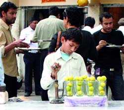 A young boy sells water on World Day Against Child Labour