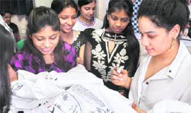 Fashion designer Masaba Gupta signs autographs for INIFD students in Ludhiana on Saturday.