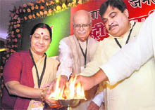 BJP national president Nitin Gadkari lights a lamp with senior leaders LK Advani and Sushma Swaraj at the two-day national executive meeting of the party in Patna on Saturday.