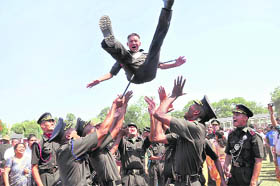 Gentlemen cadets of the Indian Military Academy throw a fellow cadet up in the air to celebrate their passing out in Dehradun on Saturday.