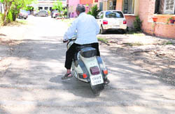 A scooterist tries to regain control over his vehicle after tripping over a speed breaker in Sector 18, Chandigarh