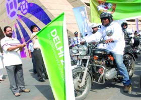 CWG organising committee chairman Suresh Kalmadi flags off a bike rally in New Delhi