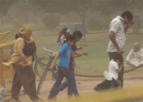 Members of a family shield themselves from a dust storm near the India Gate in New Delhi