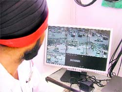 A policeman monitors the images caught by CCTVs