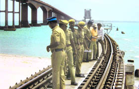 Policemen inspect the rail bridge linking the mainland with Rameshwaram island on Sunday. Security was heightened after yesterdays blast on the track at Villupuram in Tamil Nadu.