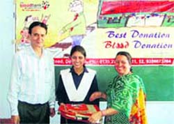 Members of the Indian Medical Association honour a motivator on the occasion of World Blood Donors Day on Monday