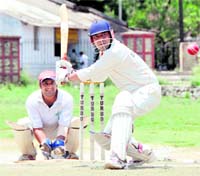 A batsman takes stance to hit a shot in a match of the Uttarakhand Challenger Cup Cricket Tournament in Dehradun on Monday