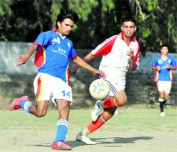Players vie for the ball during a match of the Lala Nemi Das District Football League in Dehradun on Monday