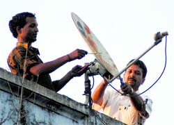 A satellite dish being installed in Dehradun