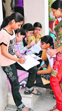 Students fill admission forms at Government College for Women in Gurgaon on Monday. 