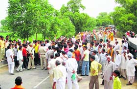 Residents block a road for highlighting their grievances near Sirsa town