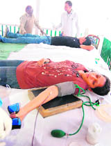 Tourists donating blood at a blood donation camp organised by the Press Club of Shimla on Monday.