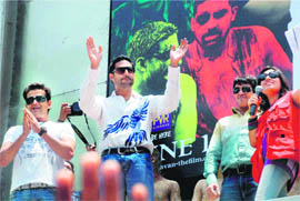 Actors Abhishek Bachchan and Ravi Kisan (L) wave to the fans during a promotional event for their upcoming film Raavan in New Delhi.  