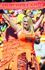 A Dutch supporter cheers for her team during their game against Denmark in Johannesburg on Monday