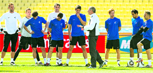 New Zealand coach Ricki Herbert (4th R) talks to his team as their training session begins at the Rotal Bafokeng Stadium in Rustenburg on Monday