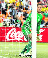 Denmarks goalkeeper Thomas Sorensen watches the ball cross the line after his teammate Simon Poulsen (not in picture) headed in the wrong direction to concede an own goal against Netherlands on Monday